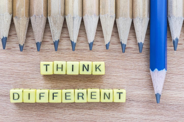 Words Think Different on wooden table with group of pencils